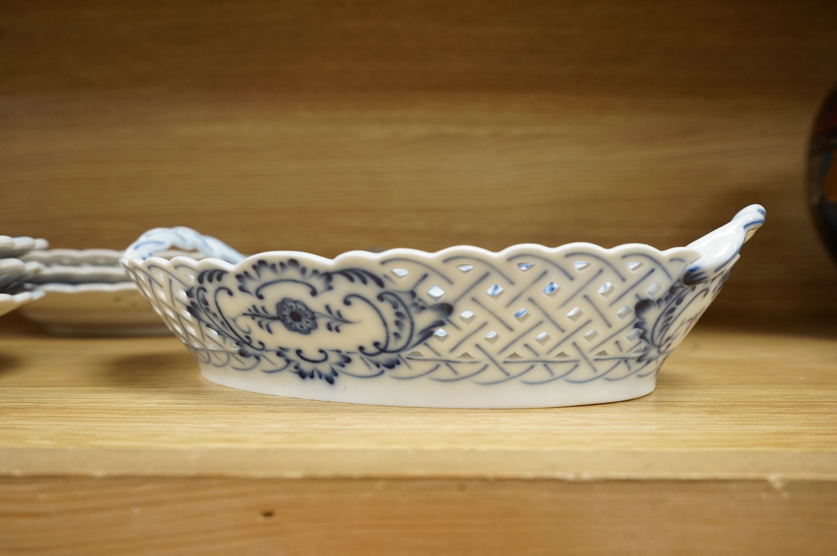 A ‘Meissen’ blue onion pattern dessert service comprising nine plates and two oval twin handled dishes, 24cm wide